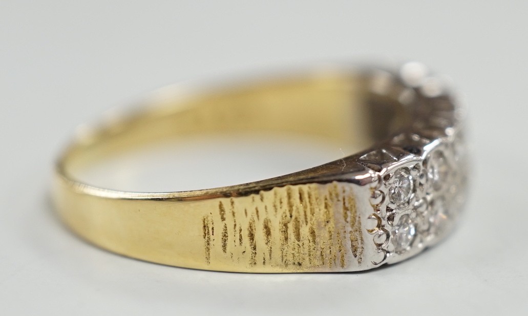 A modern 18ct gold and fourteen stone two row diamond set half hoop ring, size R/S, with textured shoulders, gross weight 5.4 grams.